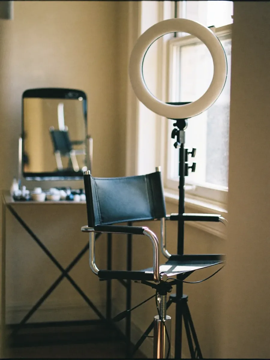 A styling chair and mirror in a bright make-up studio corner